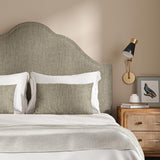 Headboard upholstered in a plain luxurious woven fabric in brown.