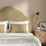 Headboard upholstered in a plain luxurious woven fabric in yellow.