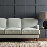 Sofa upholstered in a plain luxurious woven fabric in blue and cream.