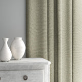 Curtain made from a plain luxurious woven fabric in brown.