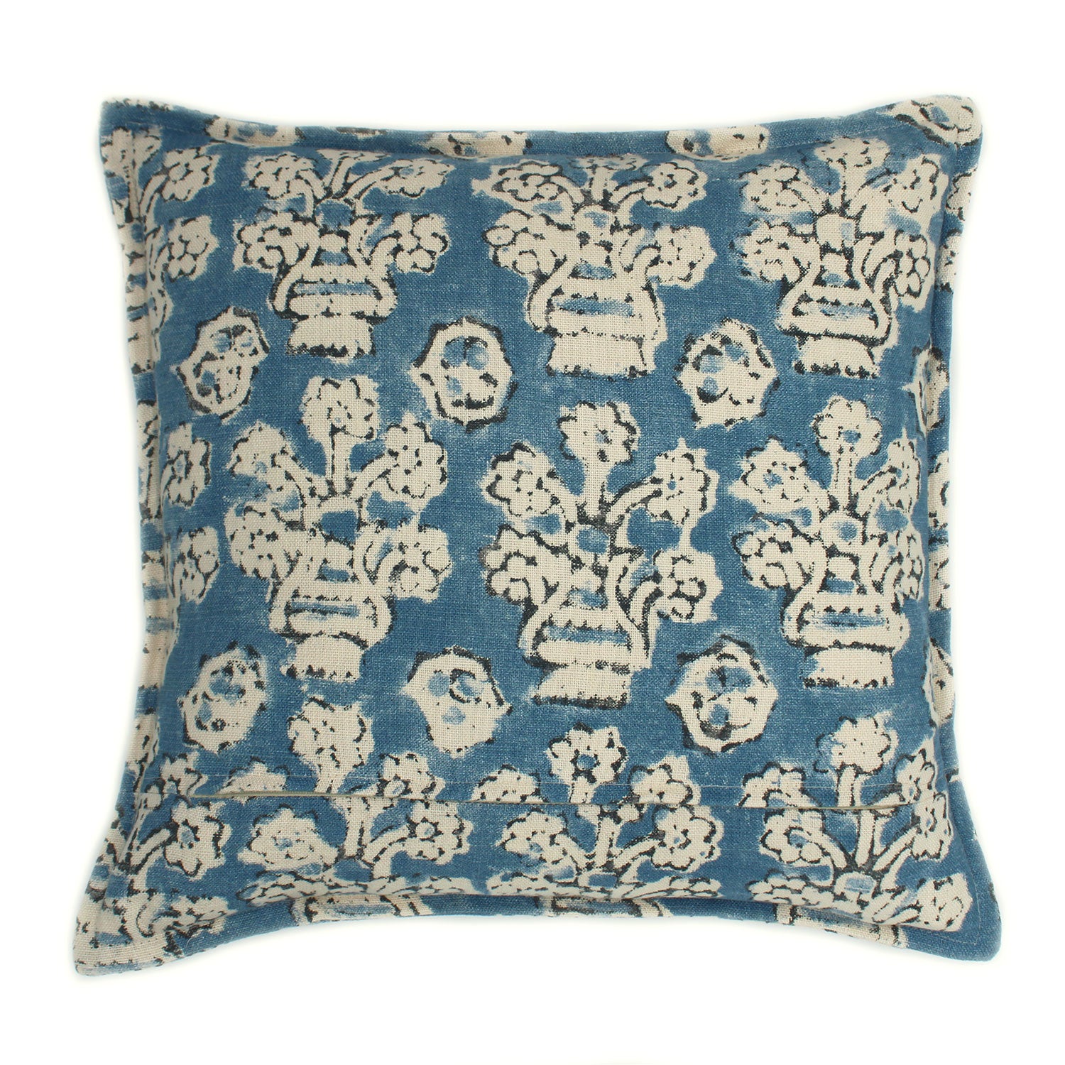 A blue, cream and black linen cushion with a block print pattern.