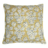 A yellow, blue and cream linen cushion with a block print pattern.