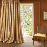 Curtains made from a printed linen fabric in yellow and off white, featuring a striped fern design.