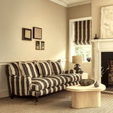 Sofa upholstered in a printed linen fabric in black and off white, featuring a striped fern design.