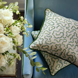 Cushions made from a printed linen fabric in blue, green, and off white featuring a feel of a classic animal print.