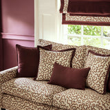 Sofa upholstered in a printed linen fabric in brown, orange, and off white featuring a feel of a classic animal print.