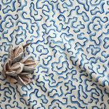 A printed linen fabric sample in blue and off white featuring a feel of a classic animal print.