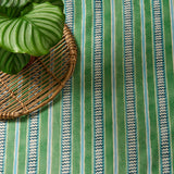 A multicoloured – green and blue – printed linen fabric sample featuring stripes, wavy edges and zigzags.