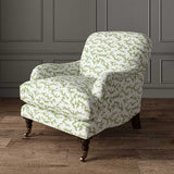 Chair upholstered in a printed linen fabric sample in green, blue and off white featuring a stylized coral pattern.
