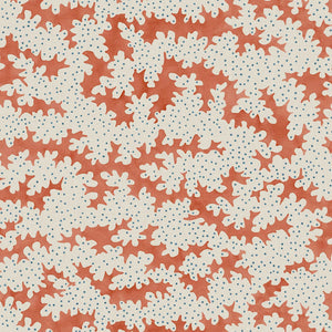 A printed linen fabric sample in orange, blue and off white featuring a stylized coral pattern.