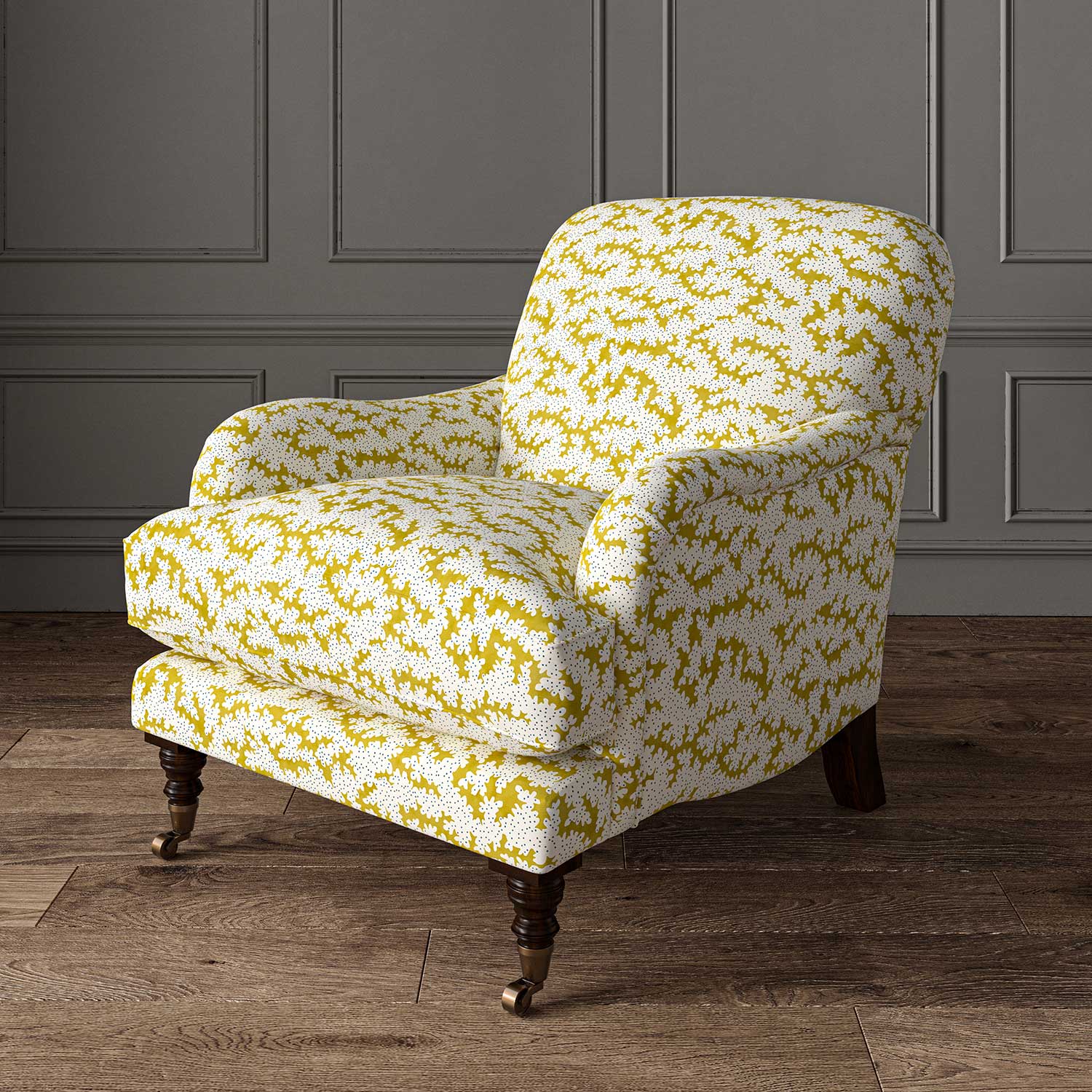 Chair upholstered in a printed linen fabric sample in yellow, blue and off white featuring a stylized coral pattern.
