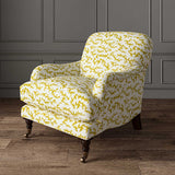 Chair upholstered in a printed linen fabric sample in yellow, blue and off white featuring a stylized coral pattern.