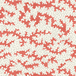 A printed linen fabric sample in red, brown and off white featuring a stylized coral pattern.