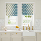 Blinds made from a printed linen fabric sample in blue and off white featuring a stylized fern pattern.
