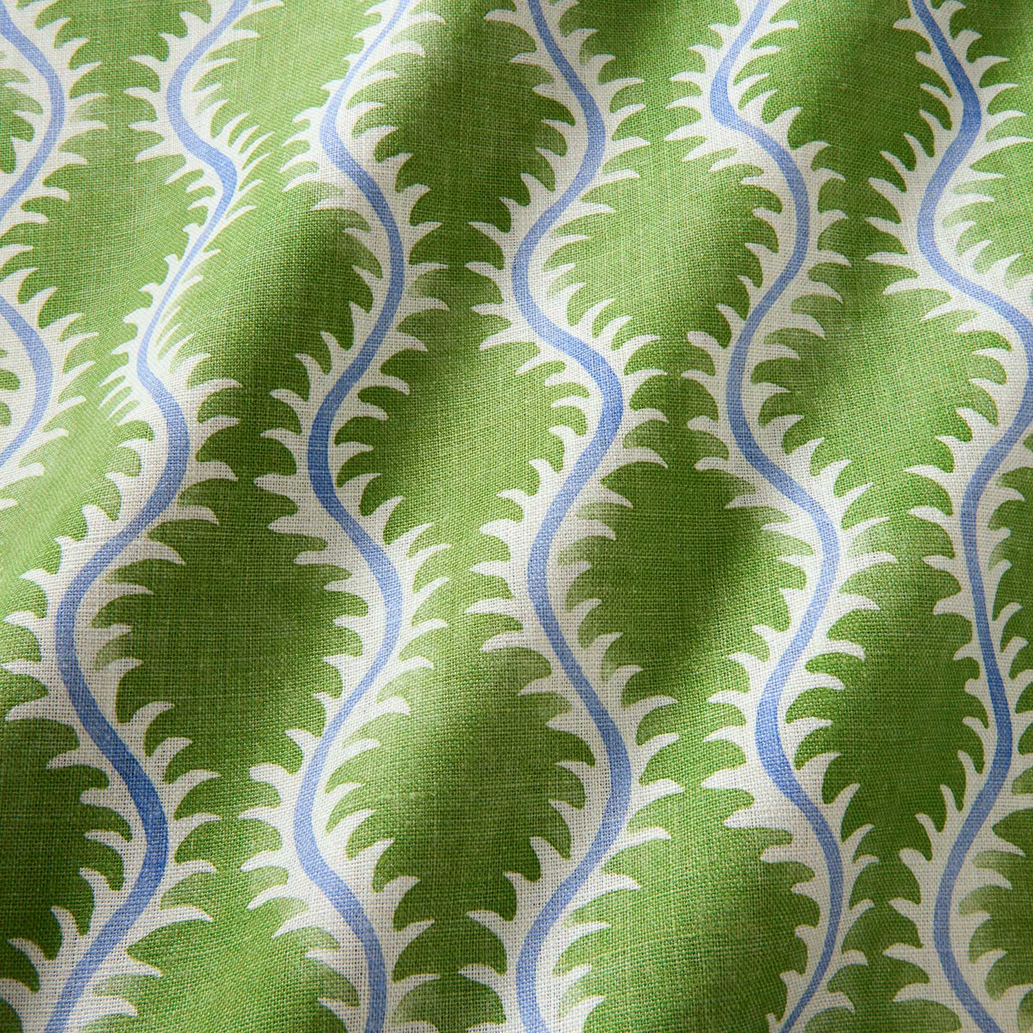 A printed linen fabric sample in blue and green featuring a stylized fern pattern.