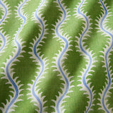 A printed linen fabric sample in blue and green featuring a stylized fern pattern.