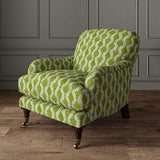Chair upholstered in a printed linen fabric sample in blue and green featuring a stylized fern pattern.