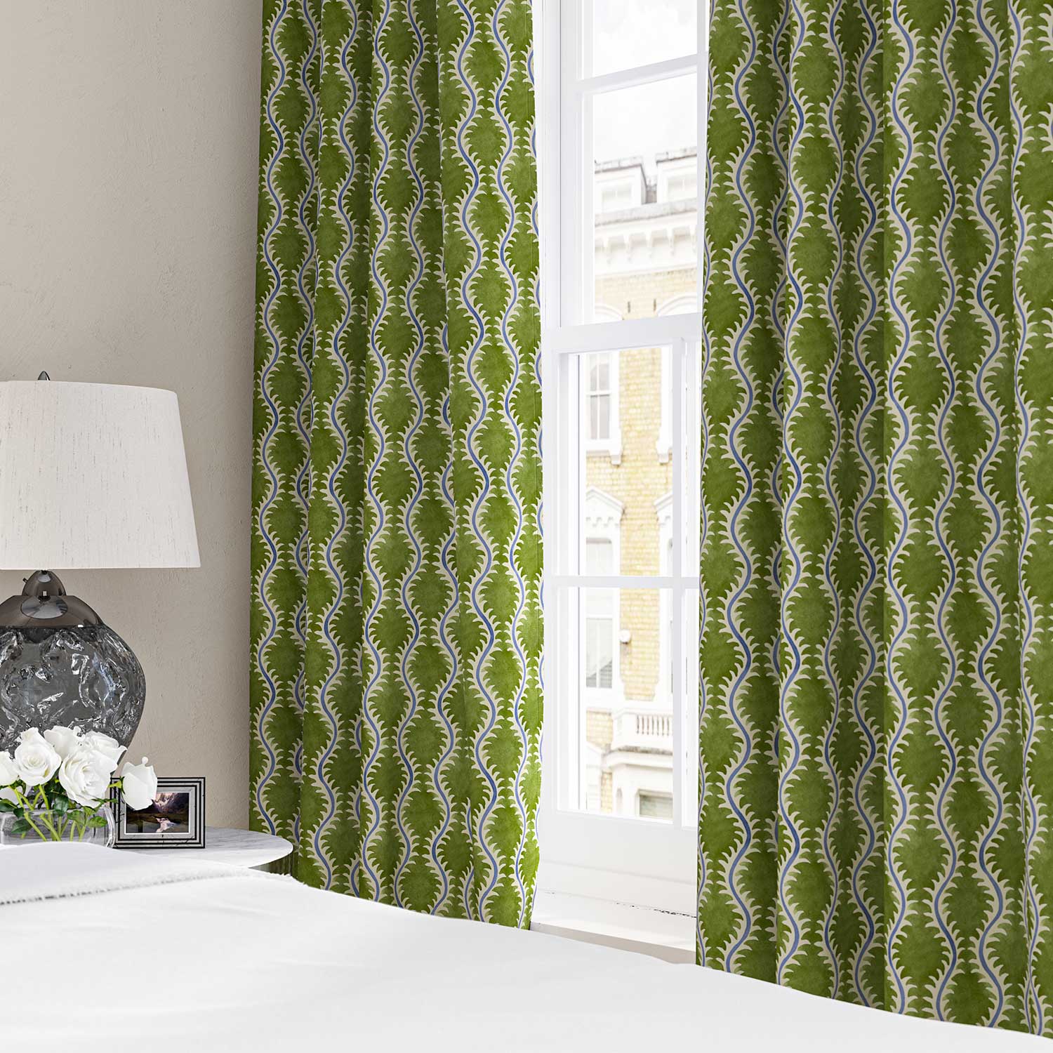 Curtains made from a printed linen fabric sample in blue and green featuring a stylized fern pattern.