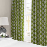Curtains made from a printed linen fabric sample in blue and green featuring a stylized fern pattern.