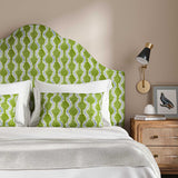 Headboard upholstered in a printed linen fabric sample in blue and green featuring a stylized fern pattern.