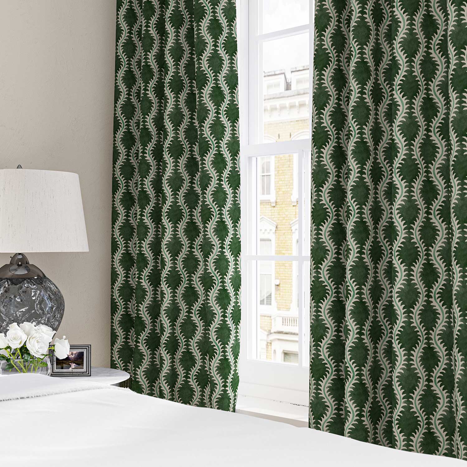 Curtains made from a printed linen fabric sample in green and off white featuring a stylized fern pattern.