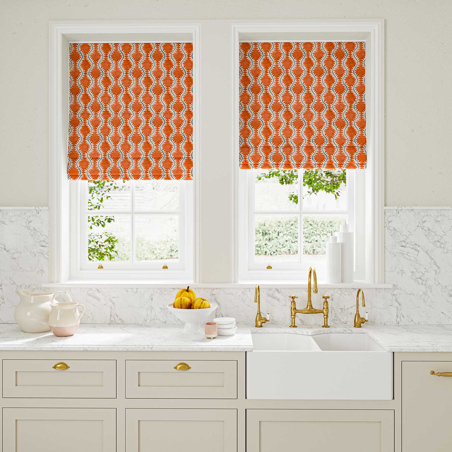 Blinds made from a printed linen fabric sample in blue and orange featuring a stylized fern pattern.