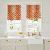 Blinds made from a printed linen fabric sample in blue and orange featuring a stylized fern pattern.