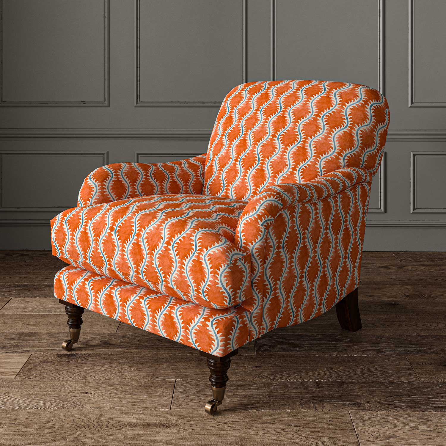 Chair upholstered in a printed linen fabric sample in blue and orange featuring a stylized fern pattern.