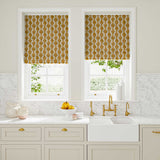 Blinds made from a printed linen fabric sample in orange, blue and off white featuring a stylized fern pattern.