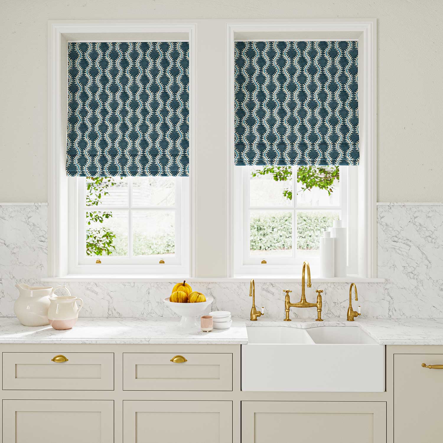 Blinds made from a printed linen fabric in blue and off white featuring a stylized fern pattern.