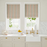 Blinds in a multicoloured – pink, red and blue – printed linen fabric featuring stripes, wavy edges and zigzags.