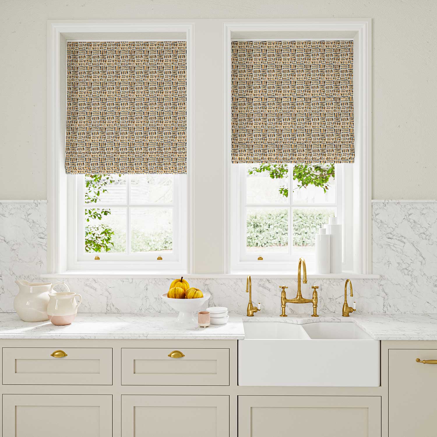 Blinds made from a printed linen fabric in black, orange and off white featuring a basketweave pattern.