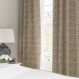 Curtains made from a printed linen fabric in black, orange and off white featuring a basketweave pattern.