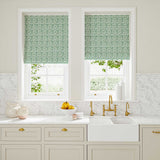Blinds made from a printed linen fabric in blue, green and off white featuring a basketweave pattern.