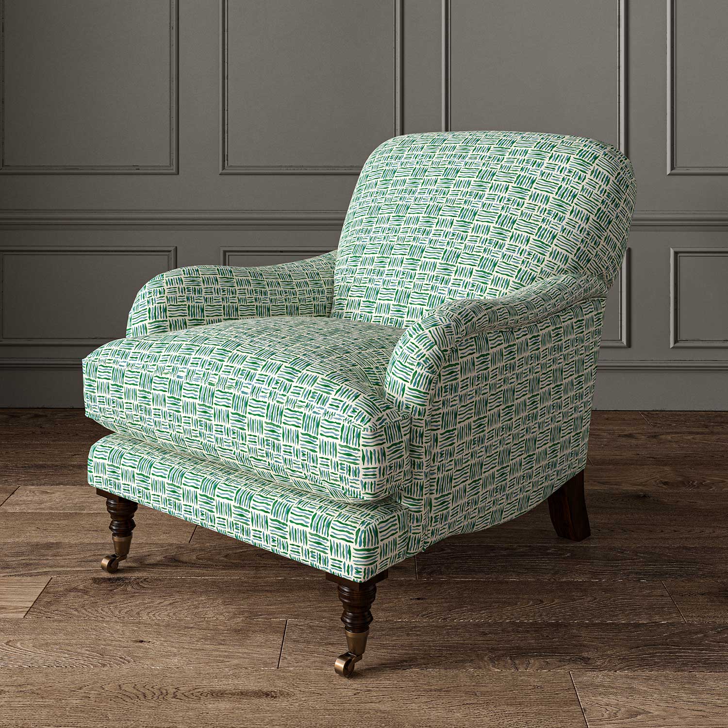 Chair upholstered in a printed linen fabric in blue, green and off white featuring a basketweave pattern.