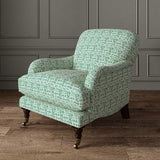 Chair upholstered in a printed linen fabric in blue, green and off white featuring a basketweave pattern.