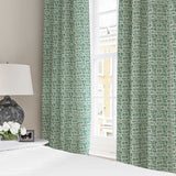 Curtains made from a printed linen fabric in blue, green and off white featuring a basketweave pattern.