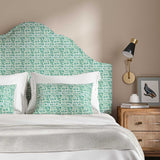 Headboard upholstered in a printed linen fabric in blue, green and off white featuring a basketweave pattern.