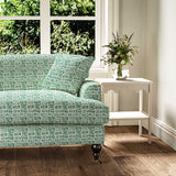 Sofa upholstered in a printed linen fabric in blue, green and off white featuring a basketweave pattern.