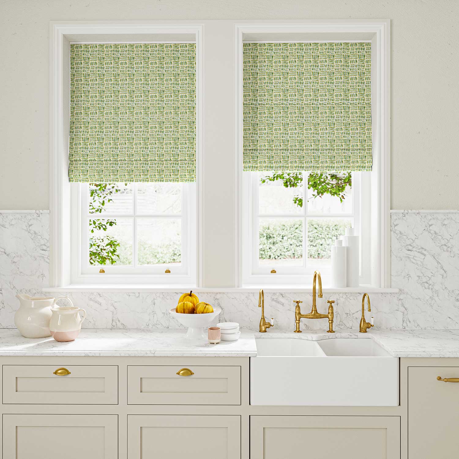 Blinds made from a printed linen fabric in green, blue and off white featuring a basketweave pattern.