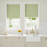 Blinds made from a printed linen fabric in green, blue and off white featuring a basketweave pattern.