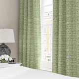 Curtains made from a printed linen fabric in green, blue and off white featuring a basketweave pattern.