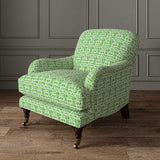 Chair upholstered in a printed linen fabric in green and off white featuring a basketweave pattern.