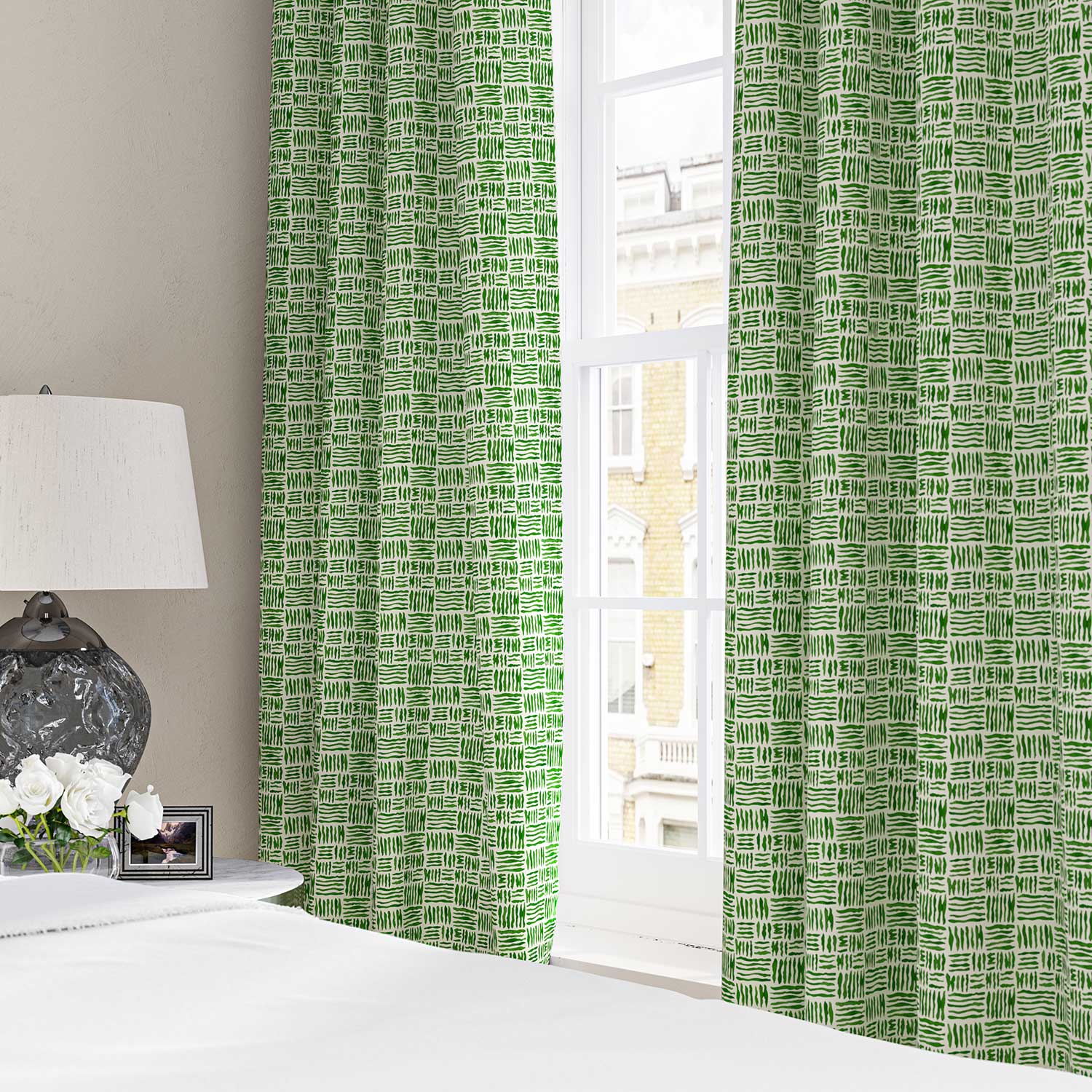 Curtains made from a printed linen fabric in green and off white featuring a basketweave pattern.