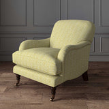 Chair upholstered in a printed linen fabric sample in yellow, blue and off white featuring a sound wave pattern