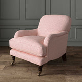Chair upholstered in a printed linen fabric sample in pink, red and off white featuring a sound wave pattern