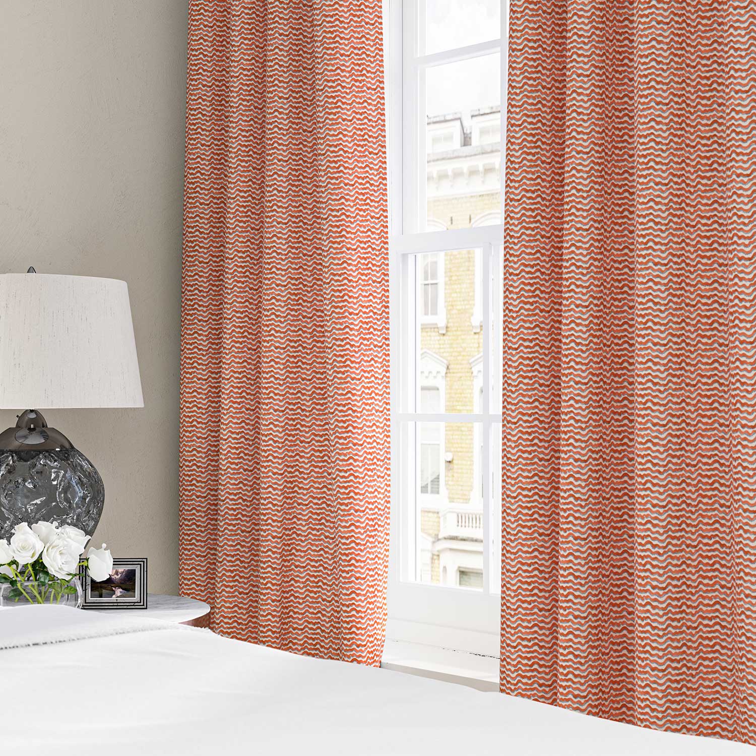 Curtains made from a printed linen fabric in red, blue and off white featuring a sound wave pattern