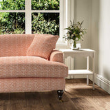 Sofa upholstered in printed linen fabric sample in a red, blue and off white featuring a sound wave pattern