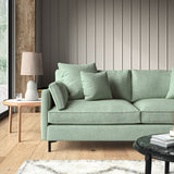 Green sofa upholstered in a chenille woven fabric.