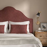 Red headboard upholstered in a chenille woven fabric.